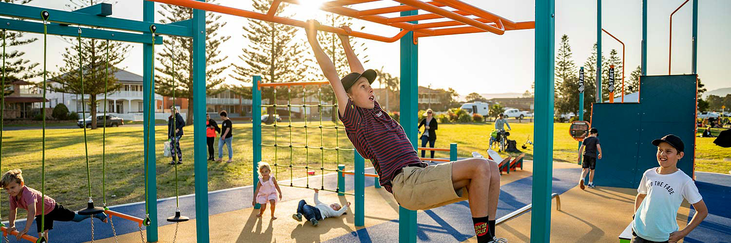 Children play on a playground at Reddall Reserve, Lake Illawarra. Credit: NSW Department of Planning and Environment