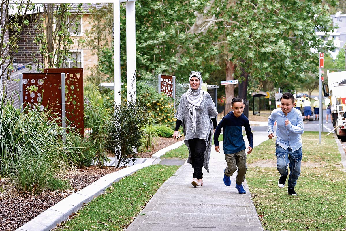 Family outside apartment block in Telopea, North West Sydney, NSW. Credit: NSW Department of Planning and Environment / Adam Hollingworth
