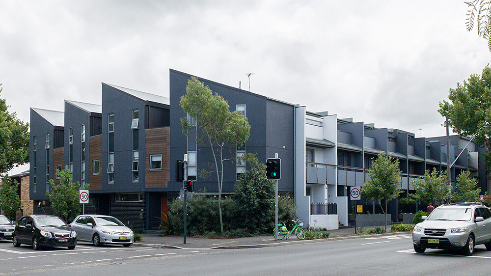 Once a car wash and petrol station, the corner site of Mitchell Road Terraces has been transformed into 13 multi-storey terrace homes and an adaptable space for commercial use. Credit: Tone Wheeler. Source: Environa Studio