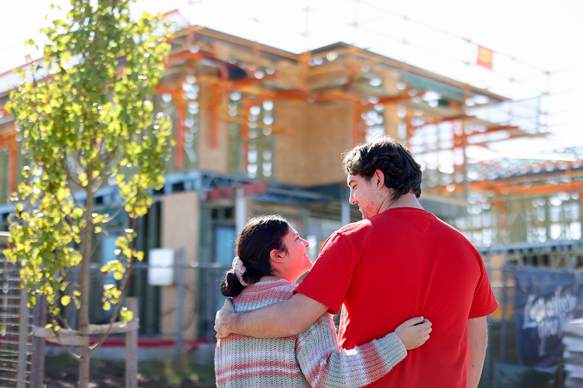 A couple stand in front of a residential housing development under construction at Marsden Park NSW. Credit: NSW Department of Planning, Housing and Infrastructure