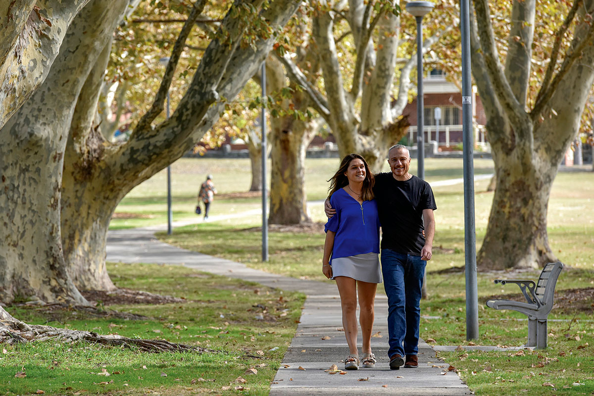 A man and woman walk through Arncliffe Park, Arncliffe, NSW. Credit: NSW Department of Planning and Environment / Adam Hollingworth