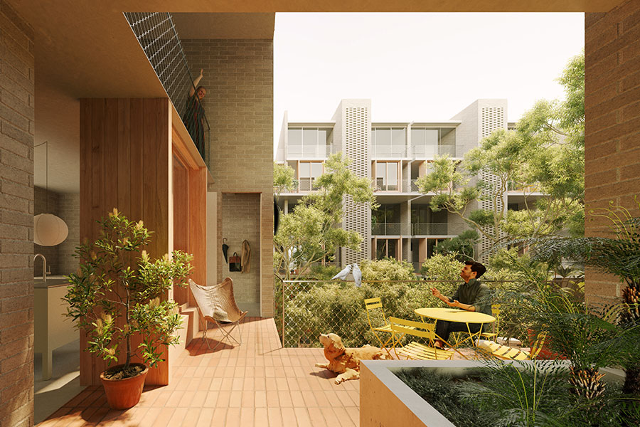 Artist's impression of a private courtyard connected to the kitchen of a timber and brick apartment. A person sits at a yellow outdoor table setting. There is a dog sitting in the sun, and there are trees and other apartments in the background.