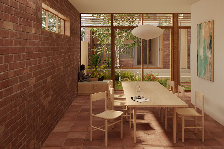 Artist's impression of an exposed brick dining room with large timber windows facing a leafy courtyard. A person sits on a small, cushioned bench in the back of the room.