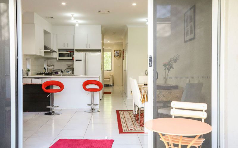 Entrance through glass sliding door into ground floor apartment kitchen.