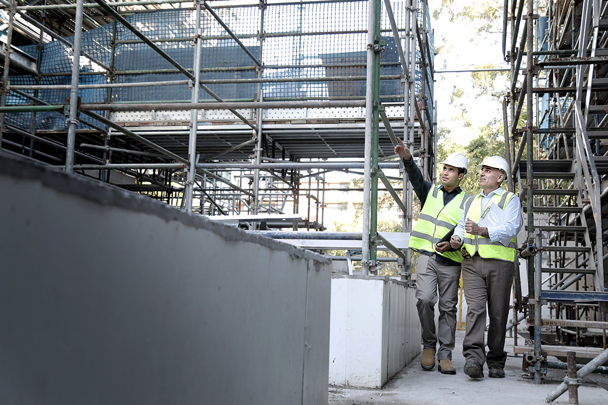 Two male building certifiers inspect a building site. Credit: NSW Department of Planning and Environment / Christopher Walters