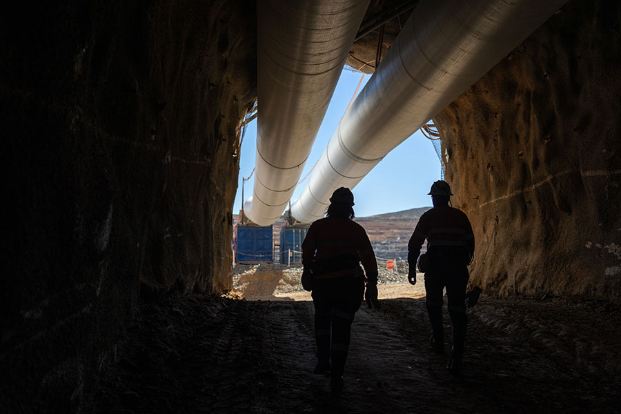 Two men walking out of an underground mine