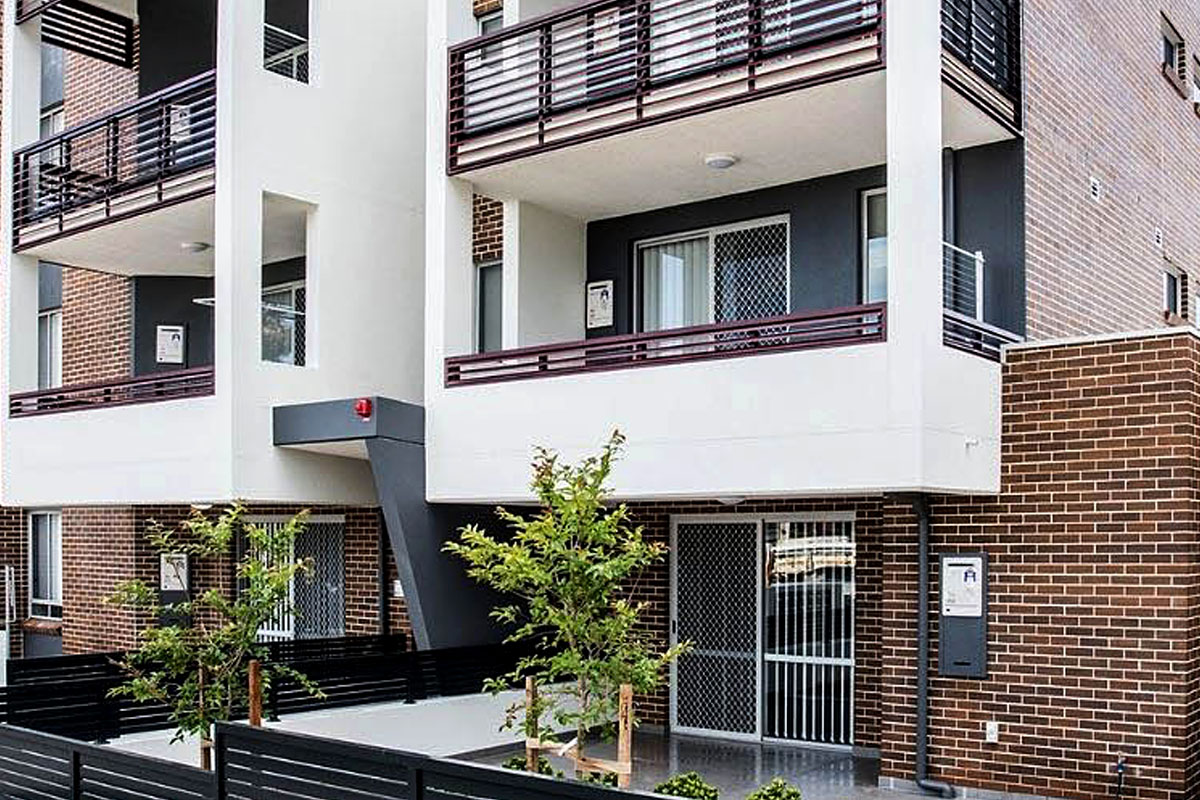 Exterior of a mid-rise building designed for social and affordable housing.