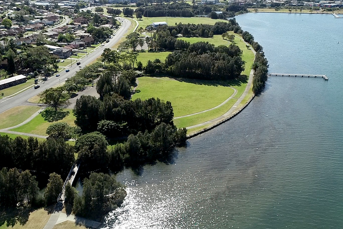 Aerial view looking down on Warrawong Parklands and surrounding waterway.