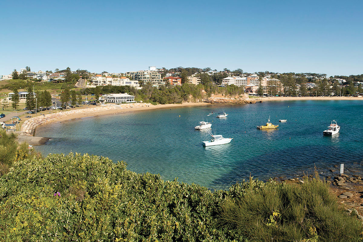 View of Terrigal Beach with boats and the nearby housing, Terrigal NSW. Credit: NSW Department of Planning and Environment / Don Fuchs