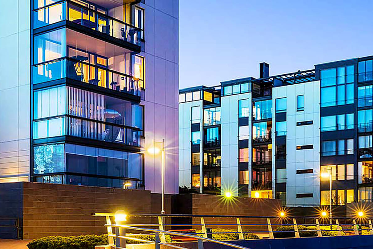 Apartment buildings reflecting lights at night.